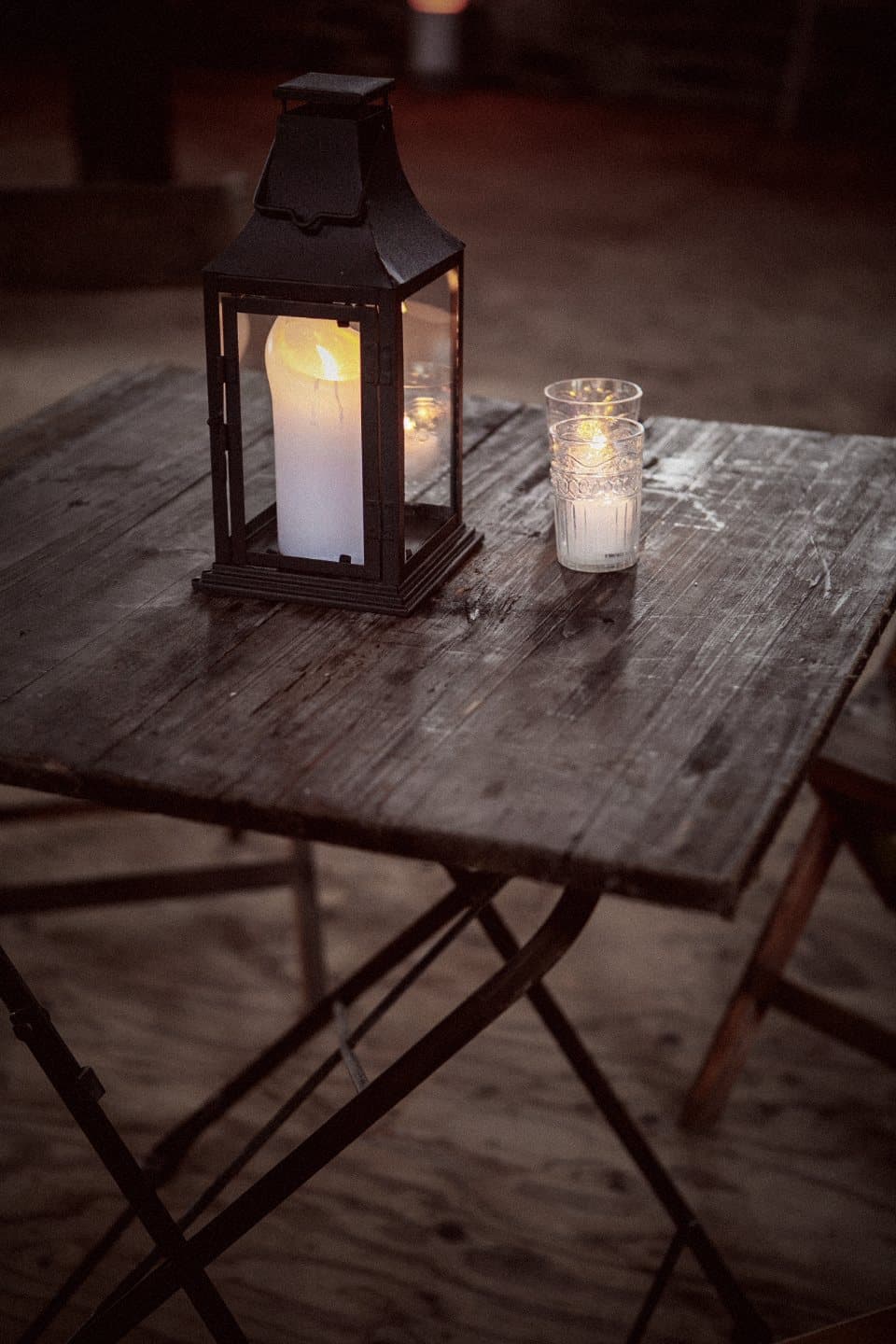 A lantern on an outdoor table at dusk