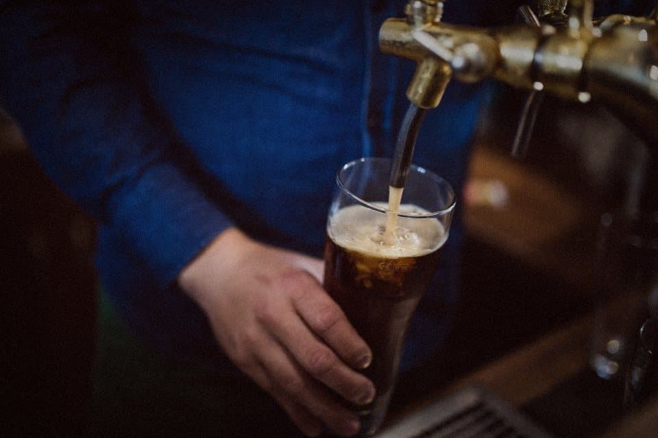 A drink being poured at the bar